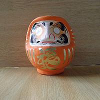 Orange colored Daruma made at Takasaki, Japan: No 1 size